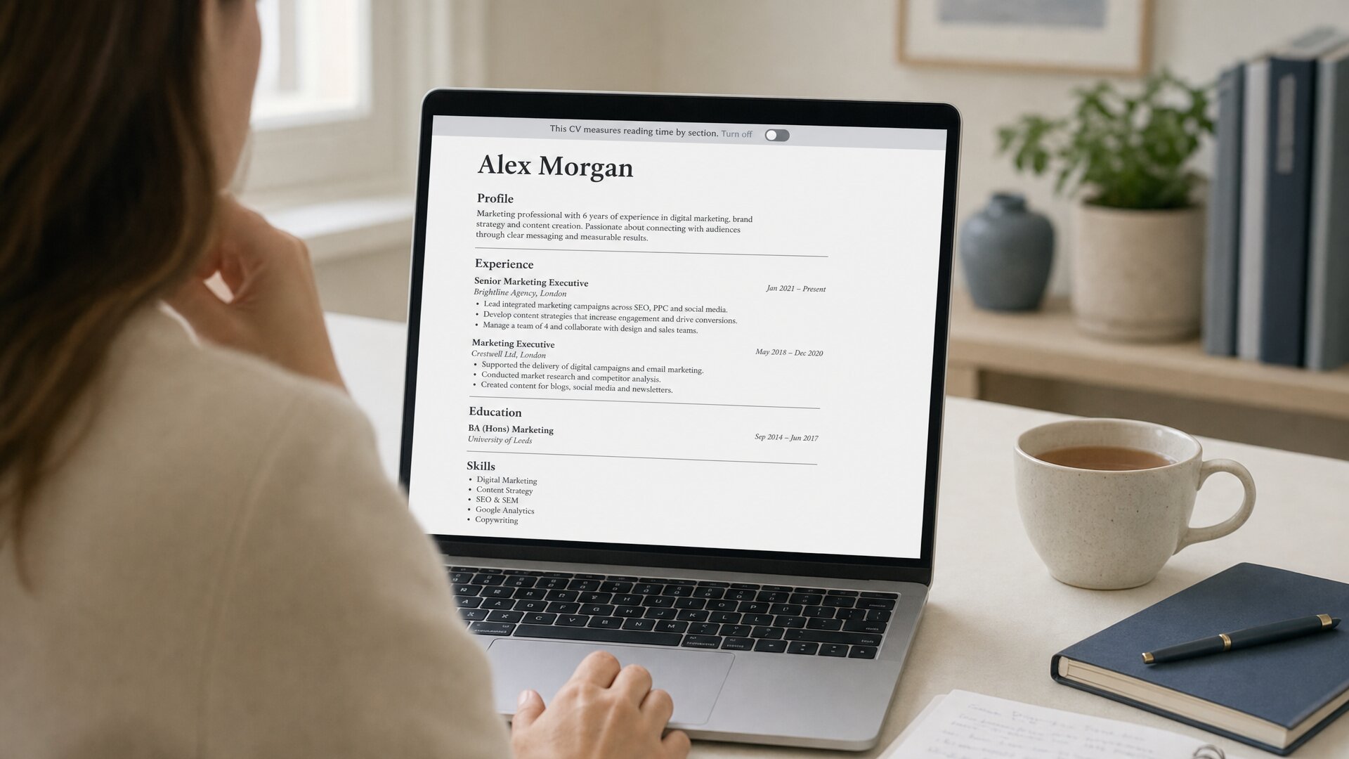A recruiter reading a CV on her laptop; a banner at the top offers to turn the measurement off.